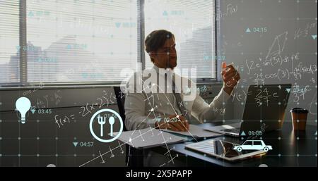 Image of multiple icons, mathematical equation and diagrams, caucasian man working on laptop Stock Photo