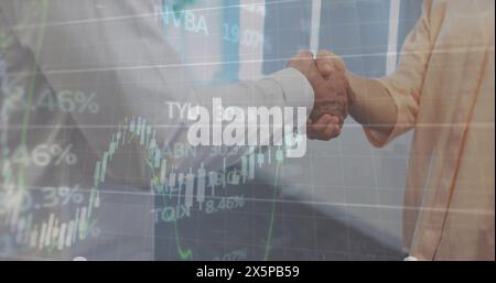 Image of multiple graphs and trading board, caucasian coworkers shaking hands Stock Photo
