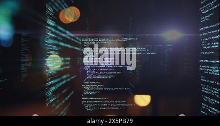 A young Caucasian professional, examining complex code on multiple screens Stock Photo