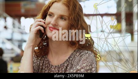 Image of connected icons forming globe over beautiful caucasian woman talking on smartphone Stock Photo