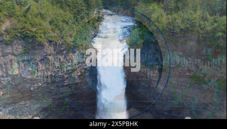 Image of financial graphs and data over waterfall Stock Photo