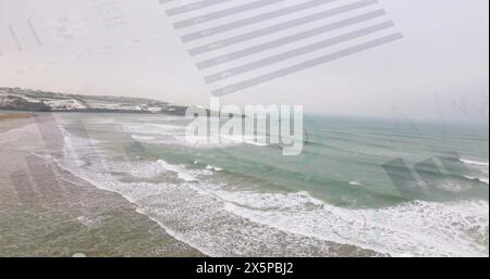 Image of financial graphs and data over seascape Stock Photo