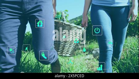 Caucasian couple holding hands, walking in field Stock Photo