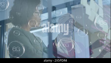 Image of multiple 6g text banners over two african american women discussing over memo notes Stock Photo