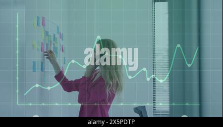 Image of financial data processing over businessman using tablet Stock Photo