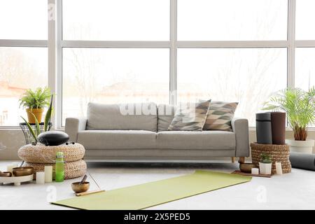 Interior of living room with sofa, glucophone and Tibetan bowl Stock Photo