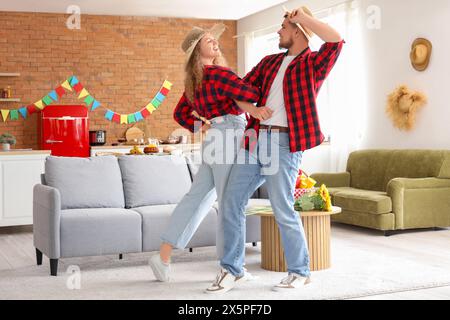 Happy young couple dancing at home. Festa Junina celebration Stock Photo