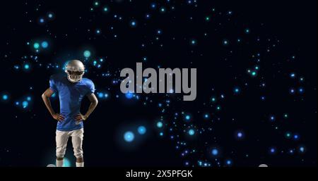 Image of american football player in helmet with arms crossed over glowing blue spots Stock Photo