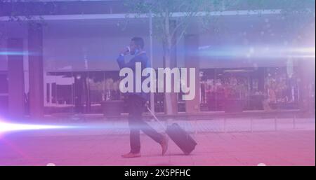 African American businessman walking, talking on smartphone Stock Photo