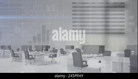 Empty office space with multiple desks and chairs, showing financial data on wall Stock Photo