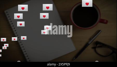 Notebook with heart stickers, coffee cup, and glasses resting on blue background Stock Photo