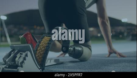 Caucasian athlete wearing running gear, crouching at starting line Stock Photo