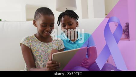Image of blue ribbon over african american siblings smiling and using tablet Stock Photo