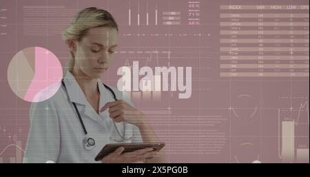 Caucasian nurse, with blonde hair, is reviewing data on tablet Stock Photo