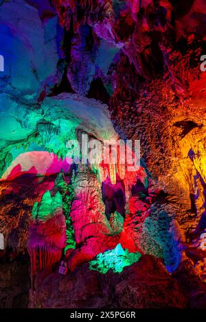 Inside the cave. Stalactites, stalagmites, colored light. Beautiful background. Silver cave Guilin China Stock Photo