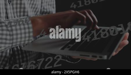 Image of data processing over hands using laptop Stock Photo