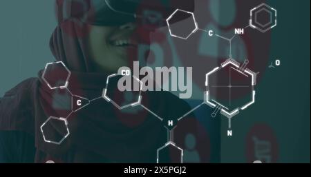 Image of chemical formulas over middle eastern woman in vr headset Stock Photo