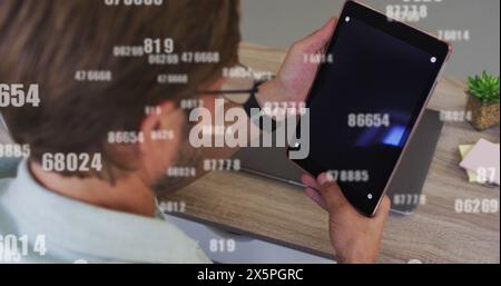 Image of data processing over caucasian man using tablet Stock Photo