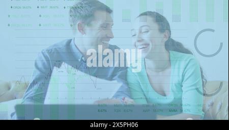 Image of stock market data processing over caucasian couple calculating finances at at home Stock Photo