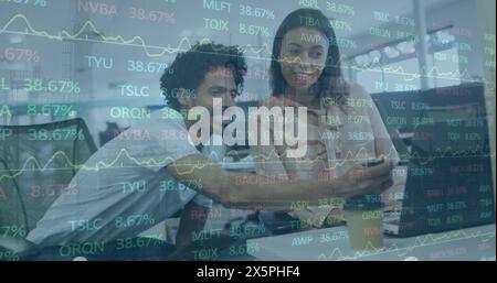 Happy diverse businesspeople using laptops and talking, symbolizing the global interconnectedness of Stock Photo