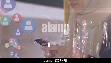 Image of globe over biracial female doctor using tablet Stock Photo