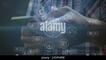Image of digital icons spinning over mid section of a man using smartphone Stock Photo