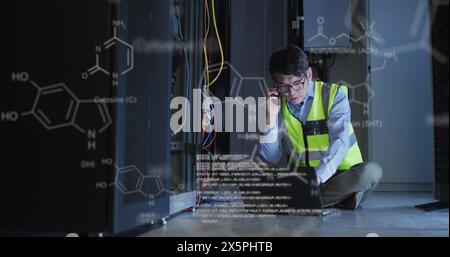 Image of medical data processing over asian male engineer talking on smartphone at server room Stock Photo