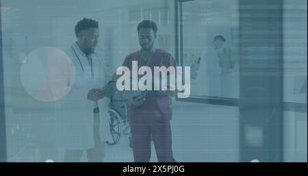 Image of data processing over two african american male doctors discussing at hospital Stock Photo