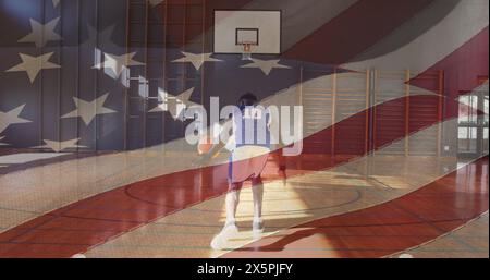 Middle-aged African American man in jersey dribbles basketball Stock Photo