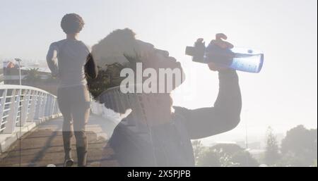 Image of african amercian man running and drinking water Stock Photo
