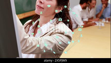Globe of digital icons over portrait of caucasian woman writing on whiteboard at office Stock Photo