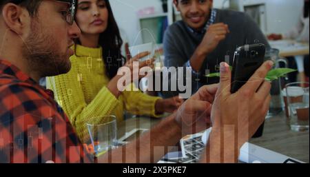 Image of statistical data processing over three diverse colleagues discussing over a smartphone Stock Photo