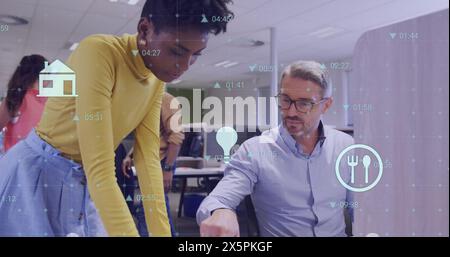 Image of icons and financial data processing over business people in office Stock Photo