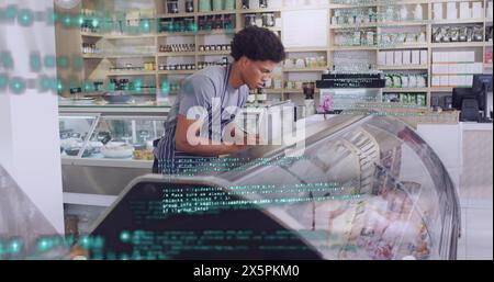 Image of financial data processing with red lines over man working in shop Stock Photo