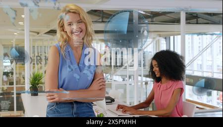 Image of sonars, computer language over diverse coworkers standing and working on desktop Stock Photo