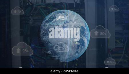 Image of changing numbers and arrow in clouds and globe over back panel of server rack Stock Photo