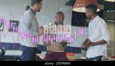 Image of multiple graphs with changing numbers, diverse coworkers discussing in office Stock Photo