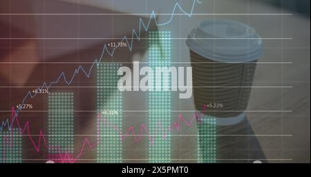Image of multiple graphs with changing numbers over coffee cup on desk Stock Photo