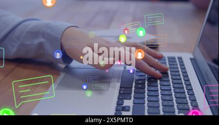 Image of profile icons floating against mid section of man using laptop at office Stock Photo