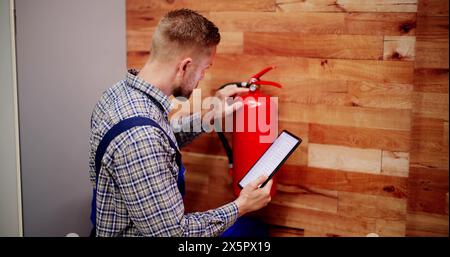 Fire Extinguisher By Handyman. Portable Extinguish Equipment Checking Stock Photo