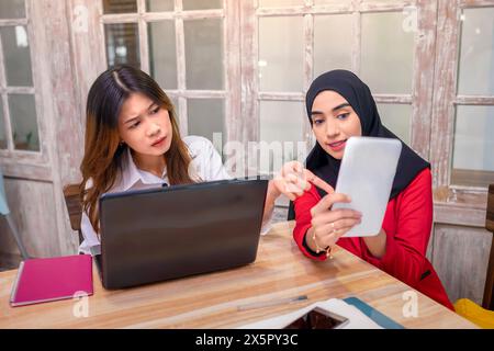 Portrait of multiethnic business colleagues discussing a business project plan during a meeting at the cafe Stock Photo