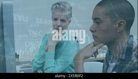Caucasian mother and biracial son looking at computer screen Stock Photo