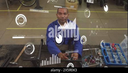 Image of multiple graphs and loading bars over biracial man repairing equipment on table Stock Photo