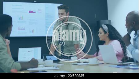 Image of numbers on round scanner over caucasian man discussing with colleagues at office Stock Photo