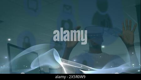 Image of waves over african american man in vr headset Stock Photo