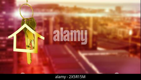 Image of gold house key and fob over out of focus cityscape Stock Photo