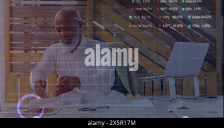 Image of financial data processing over male architect working in office Stock Photo