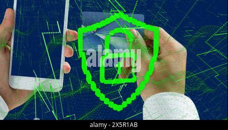 Image of digital shield with padlock over hands of caucasian man with card and smartphone Stock Photo
