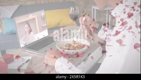 Caucasian couple enjoying virtual dinner date, male eating spaghetti Stock Photo