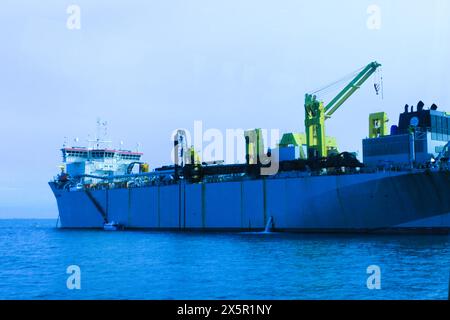 a large ship is docked in the water and is docked. Stock Photo